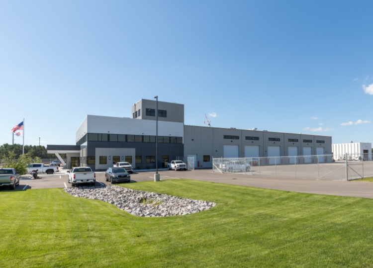 Landwehr Construction building exterior showing office and shop expansion with secured yard area, constructed by Rice Companies.