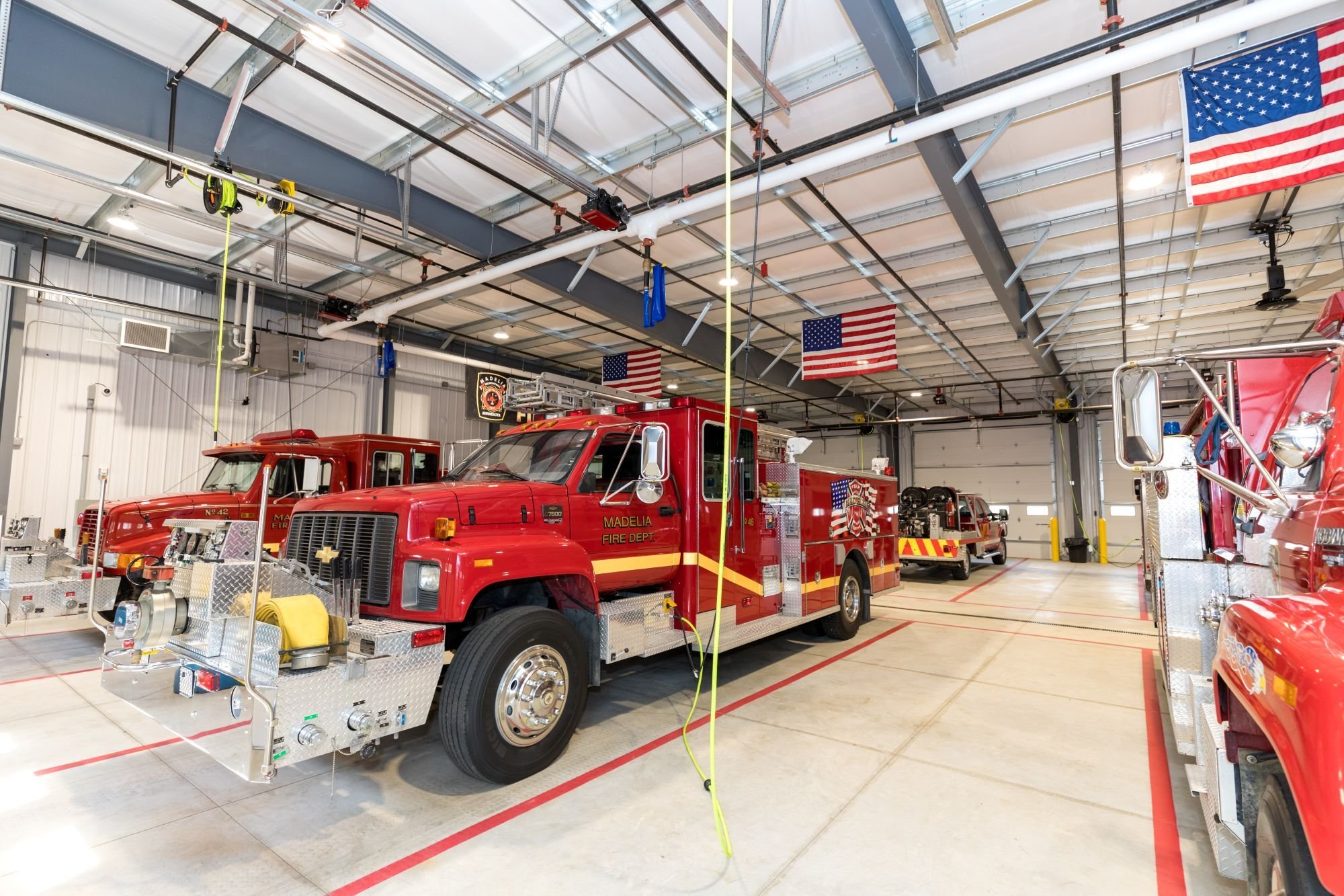 Interior of fire station facility showing apparatus bays and emergency vehicles, constructed by Rice Companies