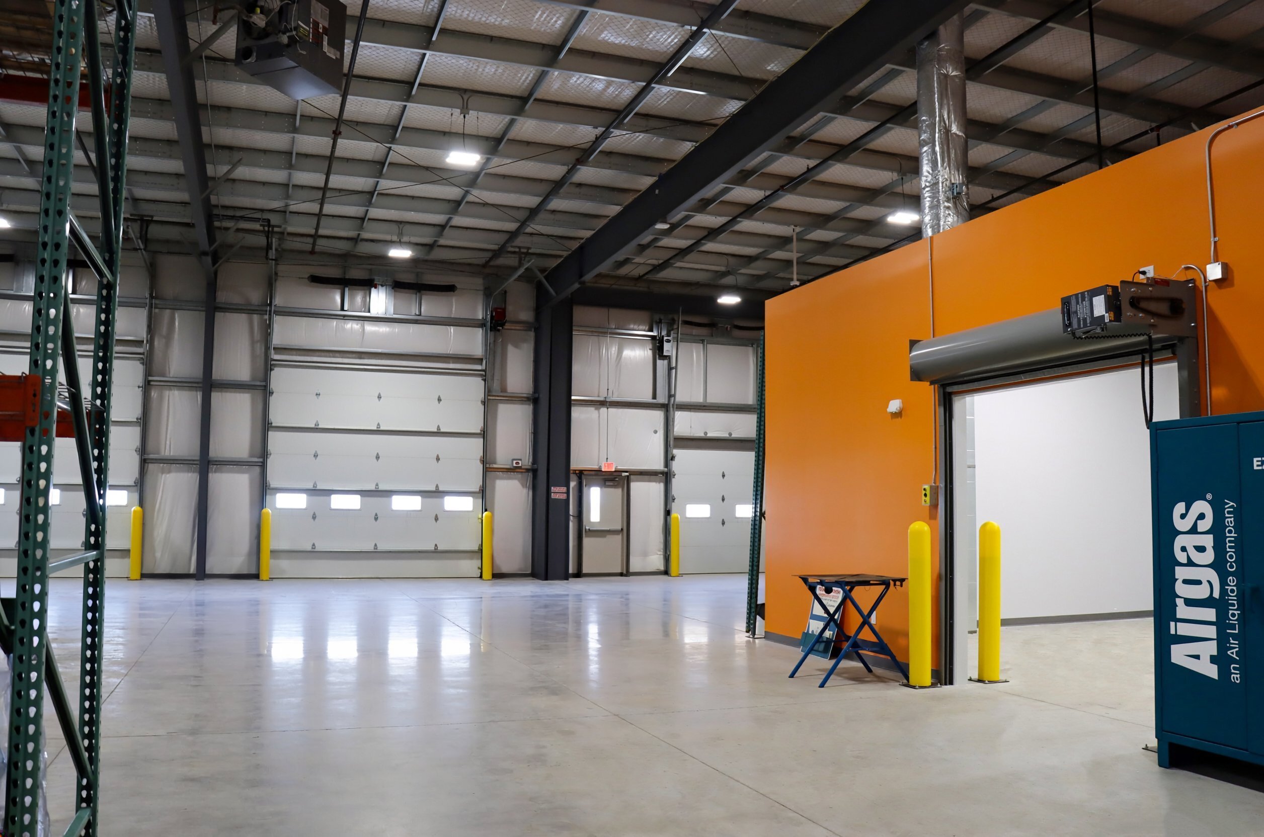 Warehouse interior with overhead doors and storage space at the Airgas facility, constructed by Rice Companies.