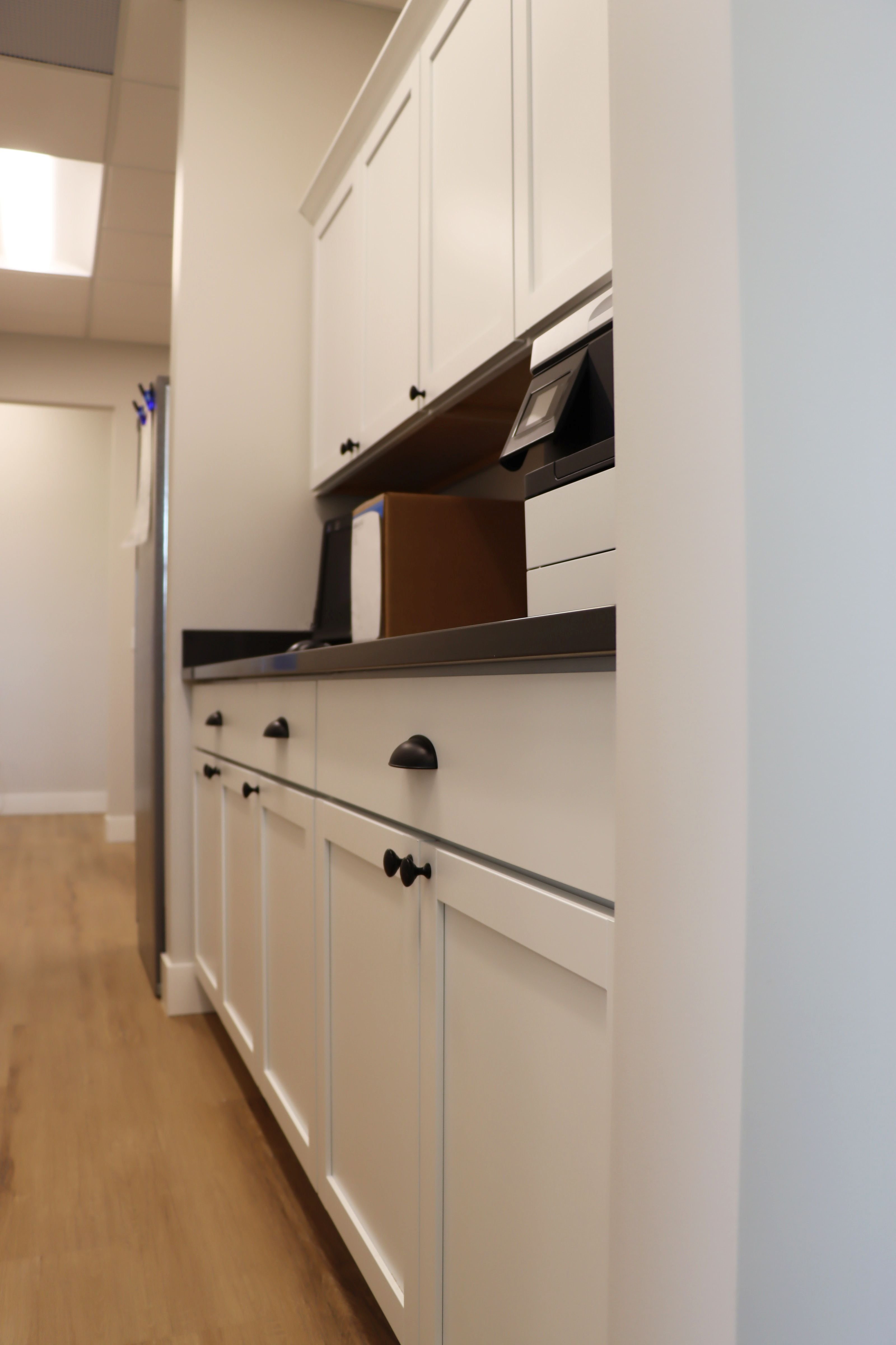 Interior of commercial office building showing kitchenette and cabinetry, constructed by Rice Companies