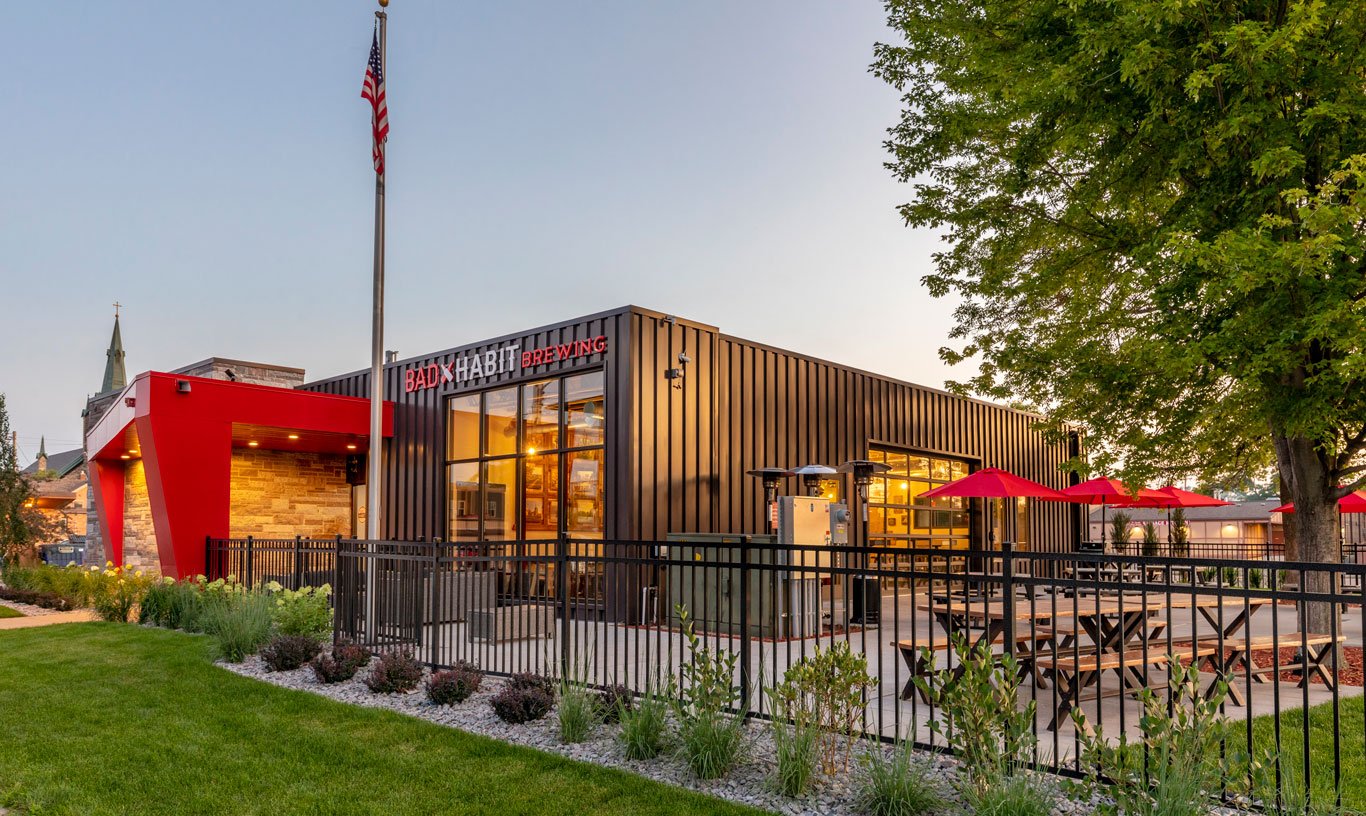 Exterior of brewery addition showing patio seating and storefront, constructed by Rice Companies