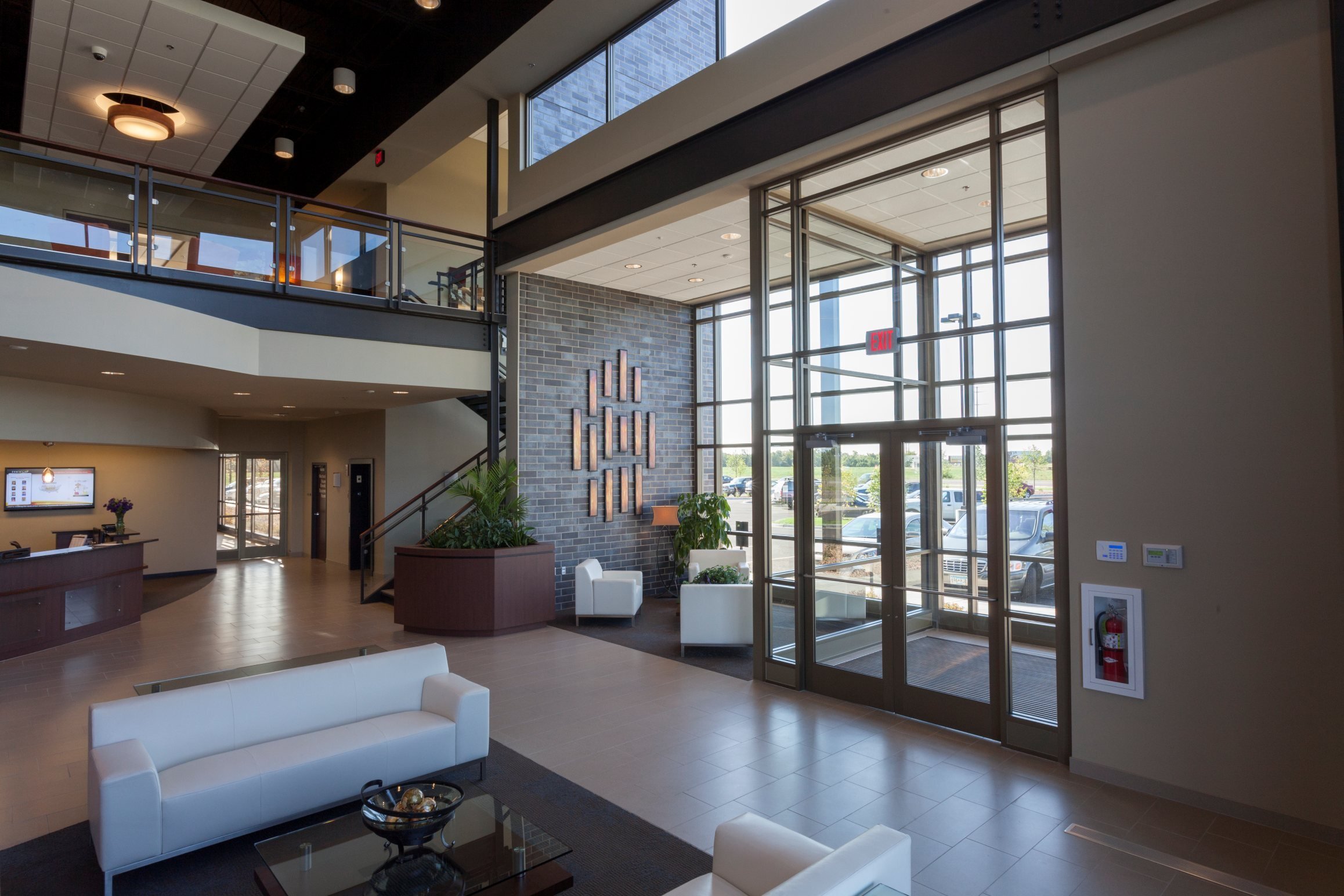 Interior of corporate headquarters showing reception area and two-story glass entry, constructed by Rice Companies
