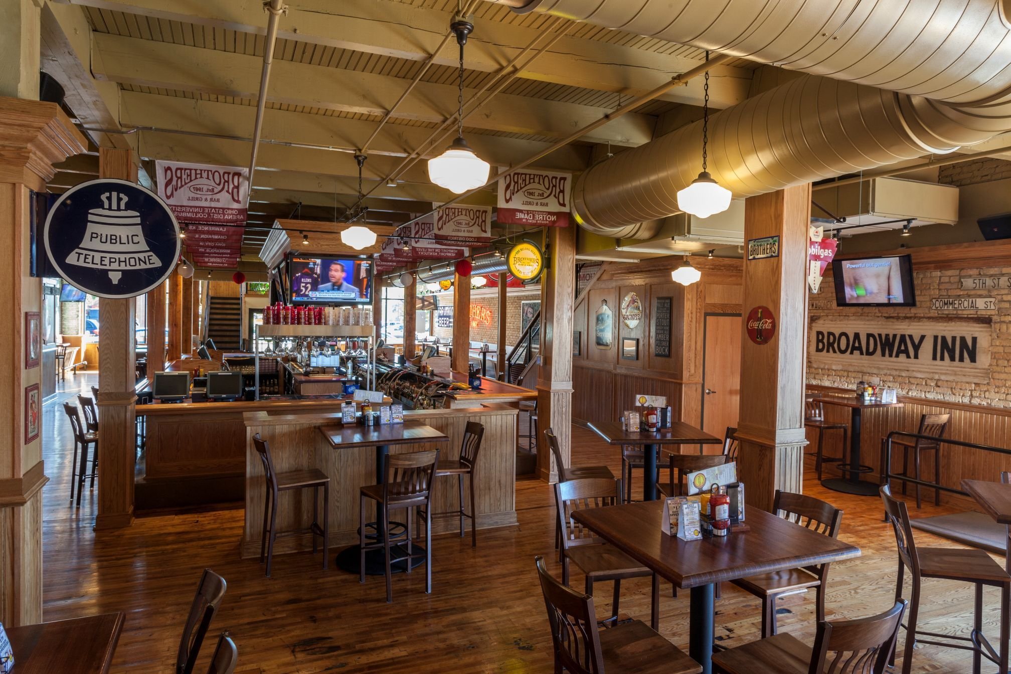 Restaurant interior at Fifth Avenue Live featuring preserved brick and updated finishes by Rice Companies.
