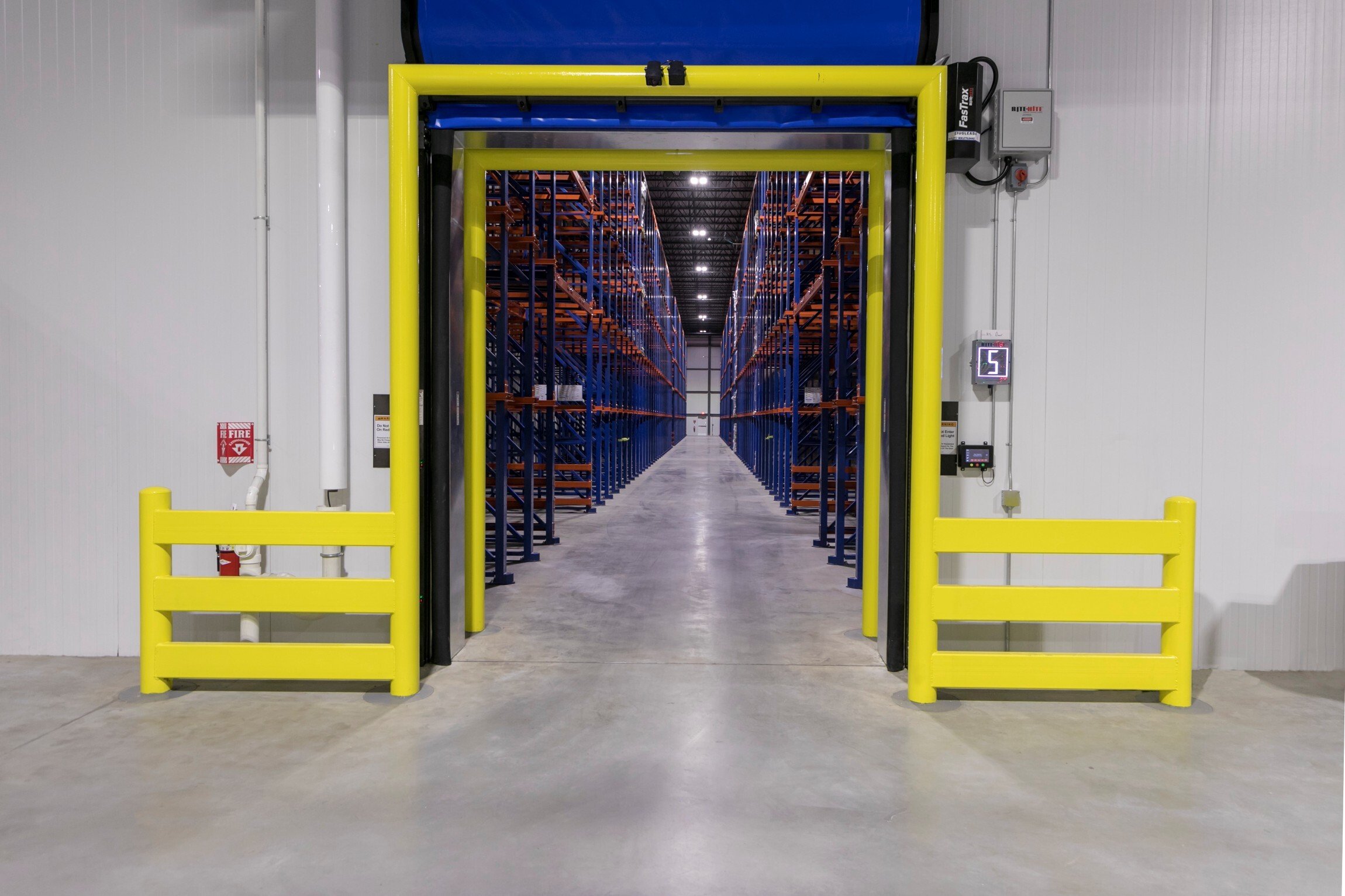 Interior of cold storage facility showing insulated freezer entry and racking aisles, constructed by Rice Companies