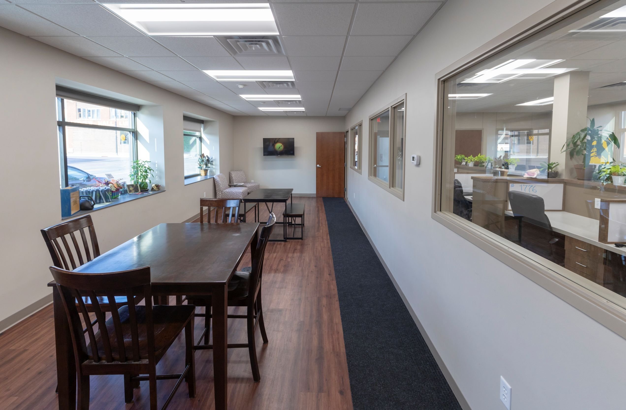 Interior hallway and collaborative meeting area within Dayta office remodel completed by Rice Companies.