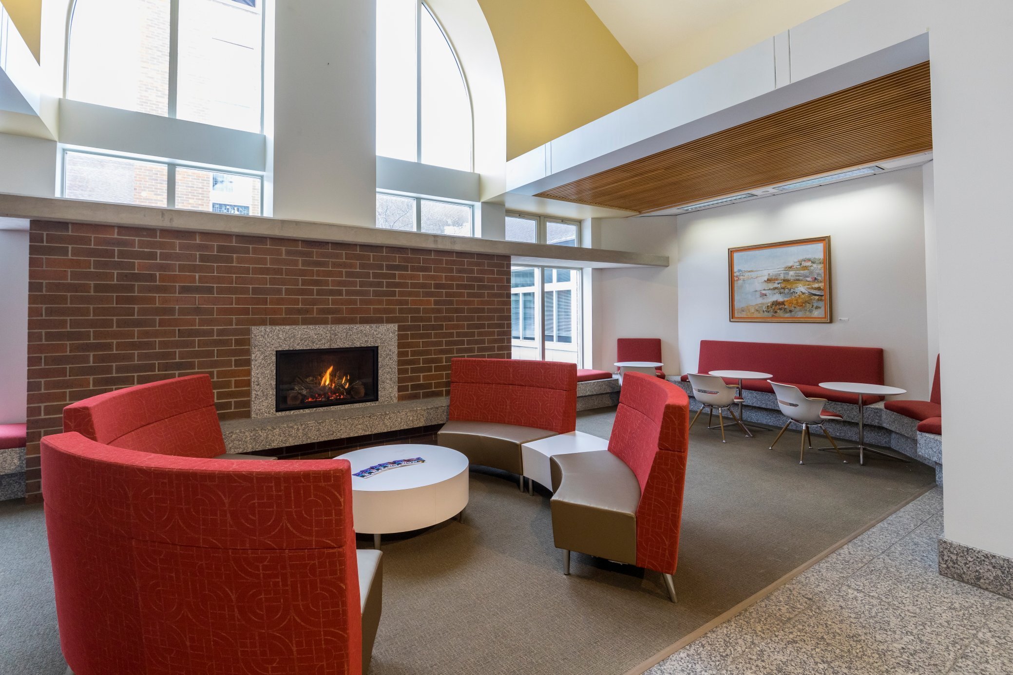 Interior of renovated education facility featuring updated lounge seating and fireplace, constructed by Rice Companies