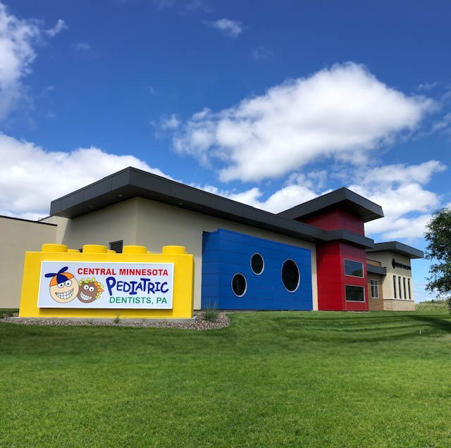 Exterior of pediatric dental clinic showing building signage and colorful facade, constructed by Rice Companies