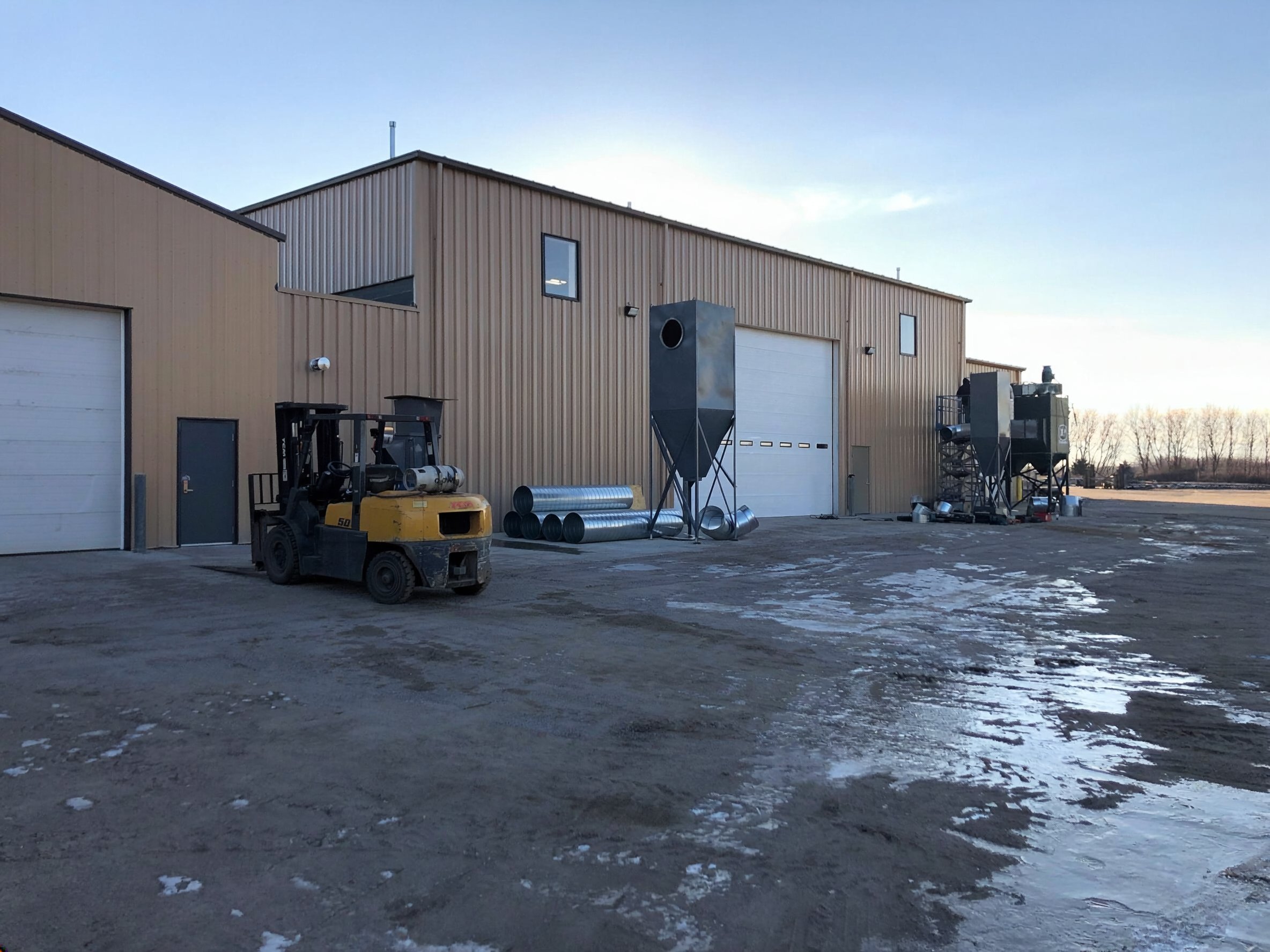 Exterior view of the CWMF plant expansion with service bays and industrial yard space, constructed by Rice Companies.