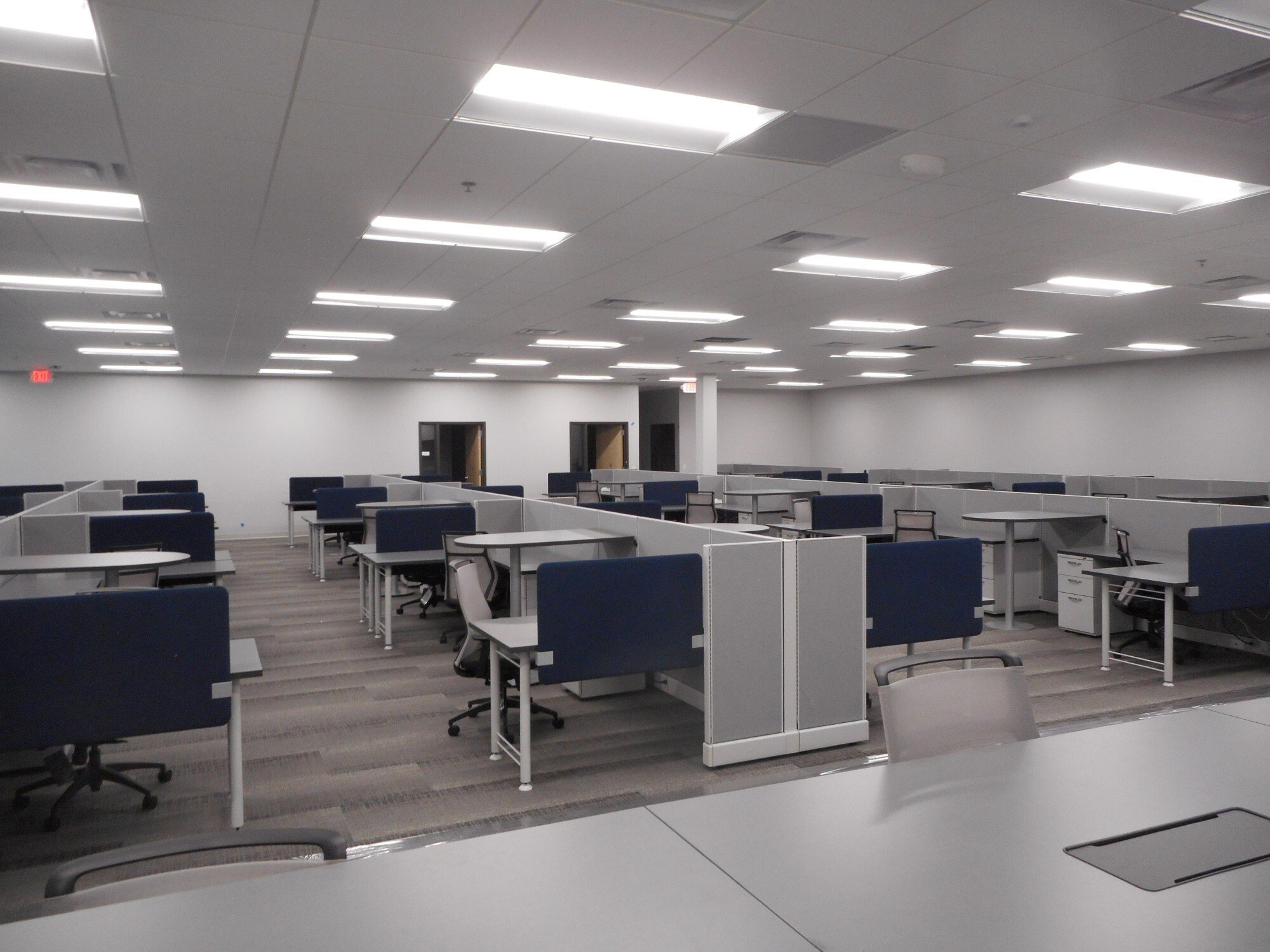 Interior of office facility showing open workspace and cubicle layout, constructed by Rice Companies.
