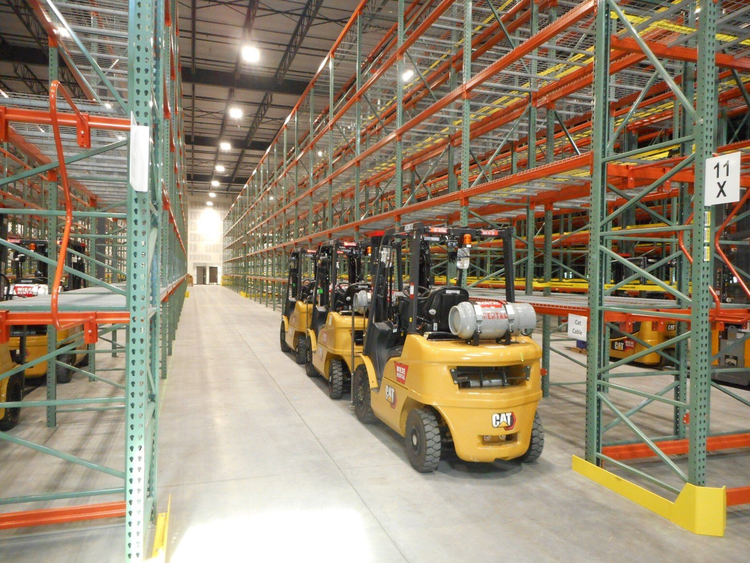 Interior of warehouse facility showing pallet racking and forklift loading aisle, constructed by Rice Companies