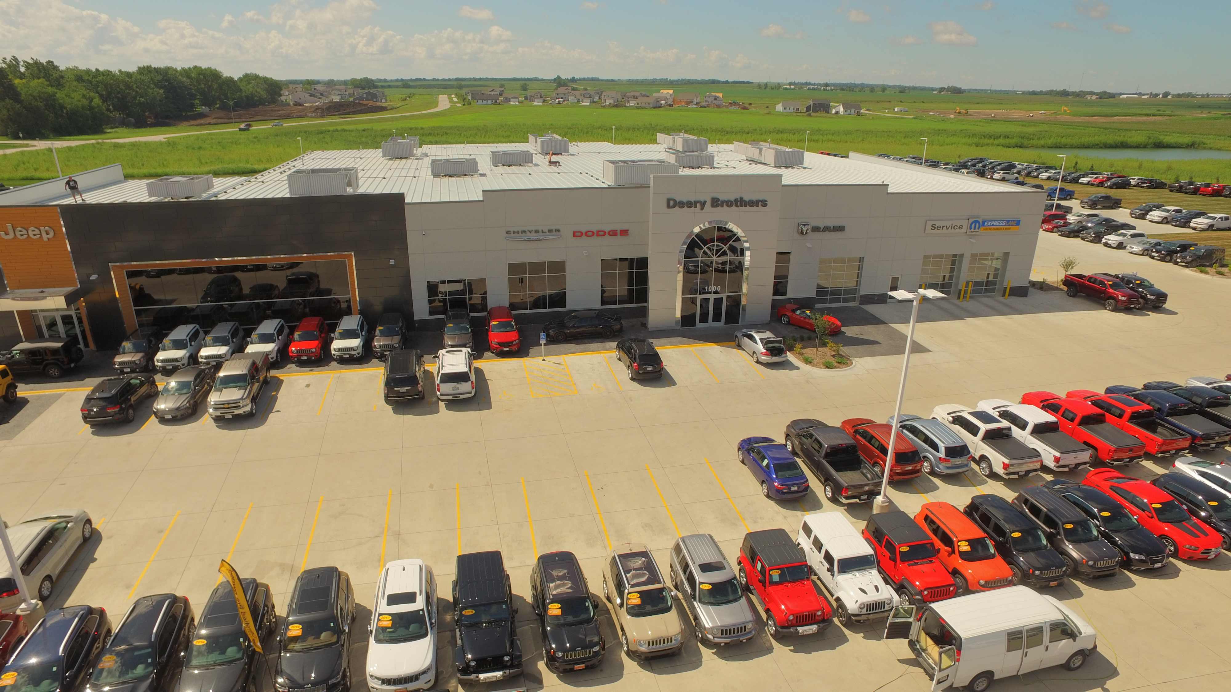 Aerial view of Deery Brothers automotive facility with dealership frontage and parking, built by Rice Companies