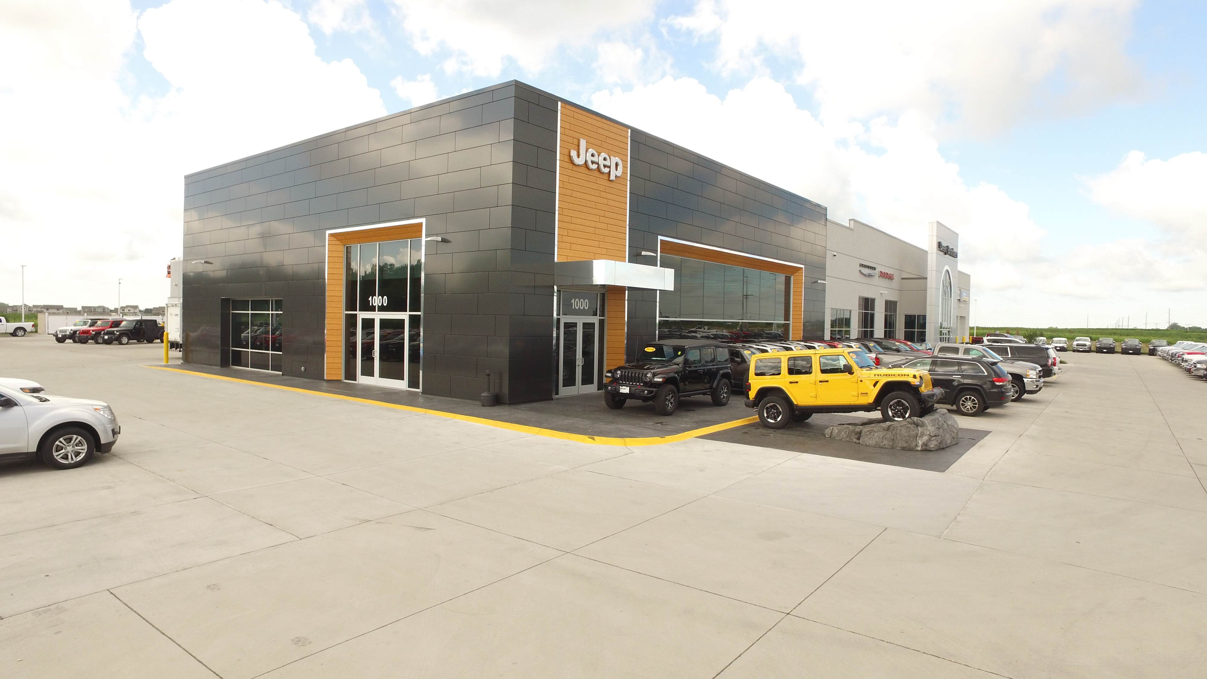 Exterior of Deery Brothers automotive dealership with Jeep showroom entrance, constructed by Rice Companies