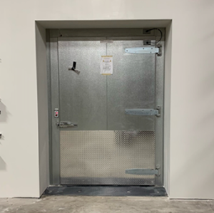 Interior of food processing facility showing insulated cold storage door, constructed by Rice Companies