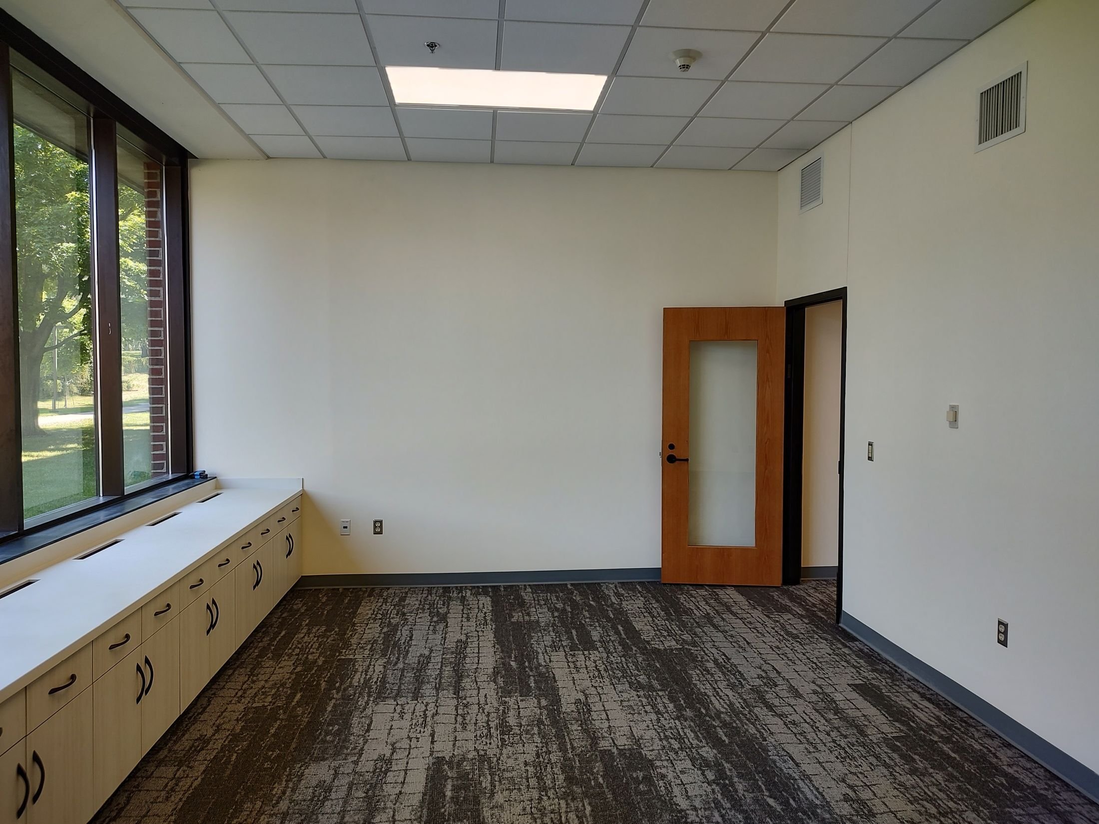 Renovated academic meeting space with updated flooring and natural light, constructed by Rice Companies