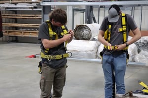 interns getting fitted for harnesses