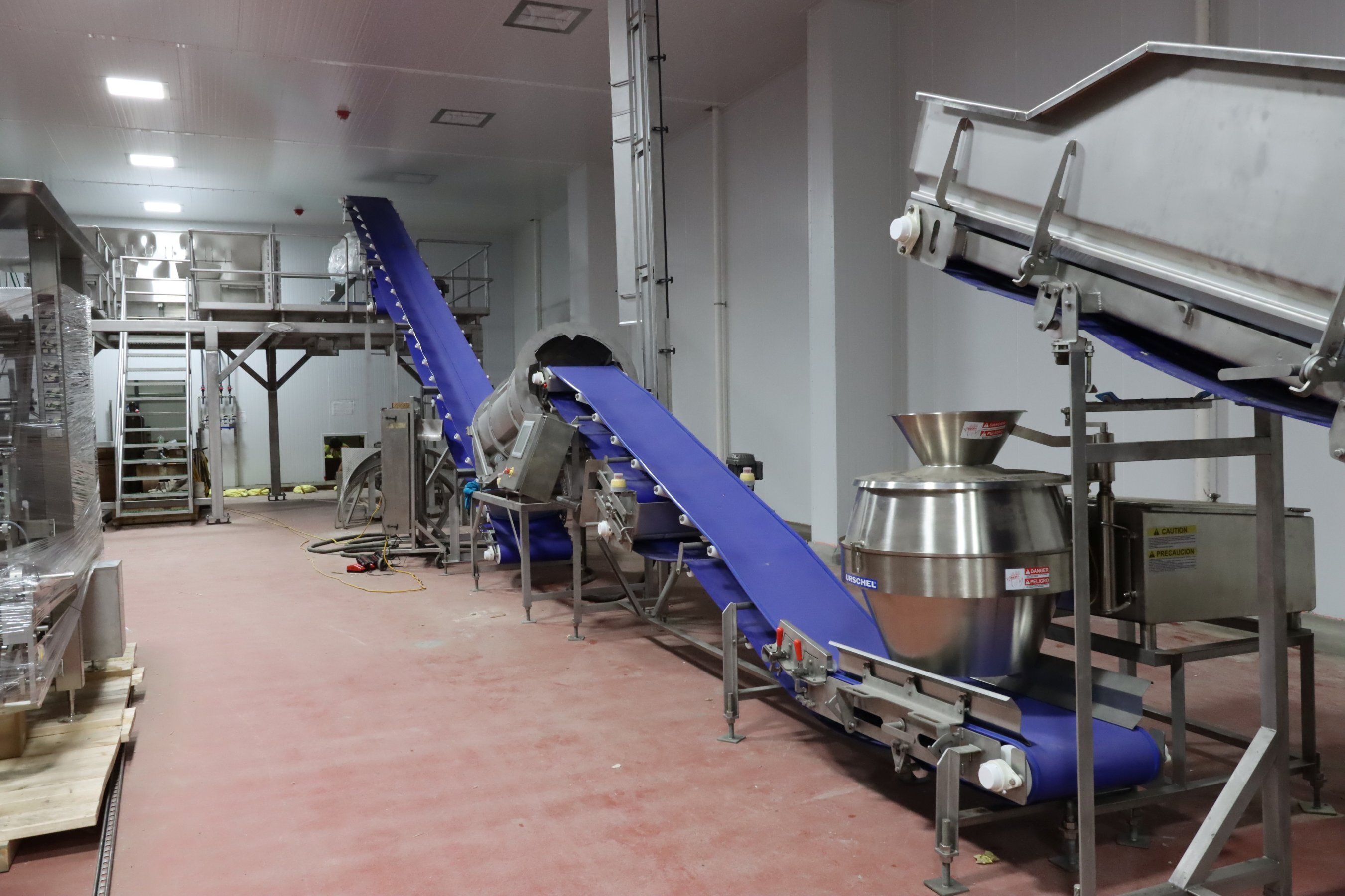 Interior of food processing facility featuring conveyor systems and production equipment, constructed by Rice Companies