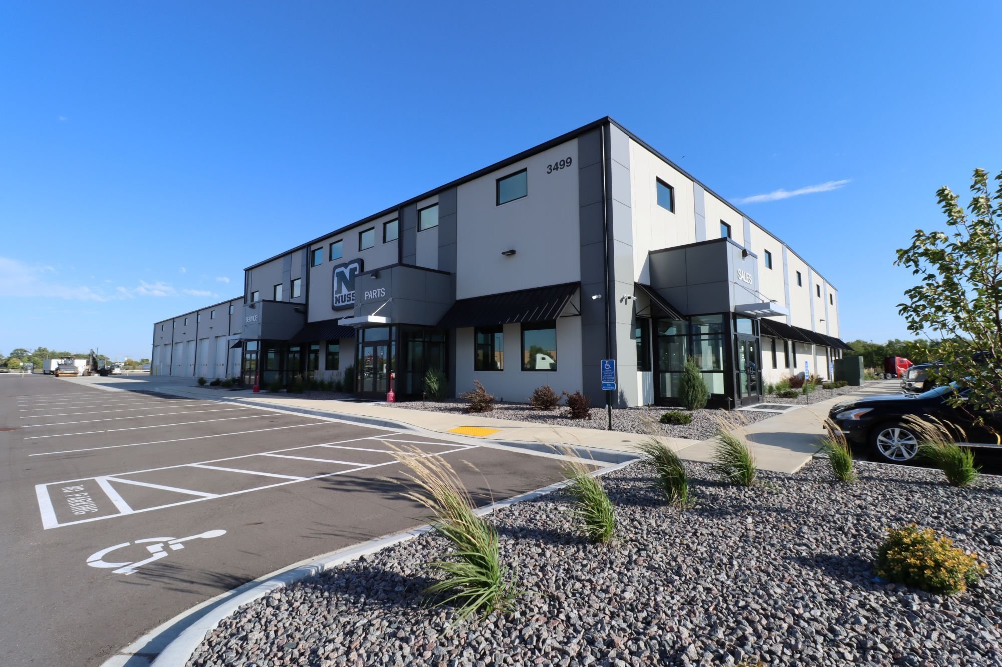 Exterior of commercial service facility showing storefront entrance and parking area, constructed by Rice Companies