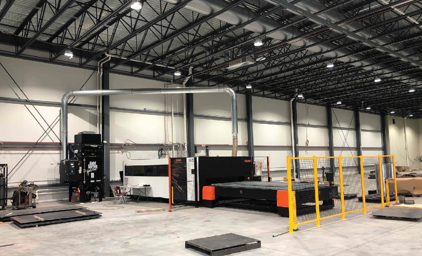 Manufacturing production floor with industrial equipment and safety railings at Virnig Manufacturing, constructed by Rice Companies.