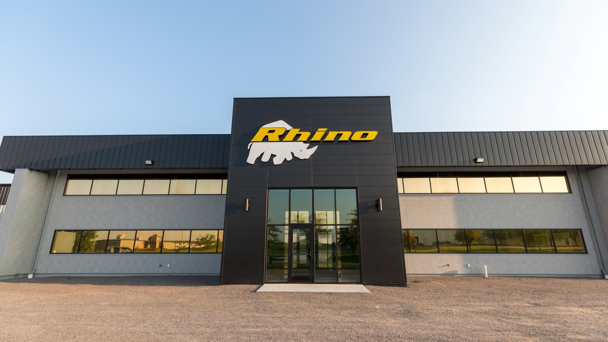 Exterior of manufacturing facility showing branded facade and main entrance, constructed by Rice Companies