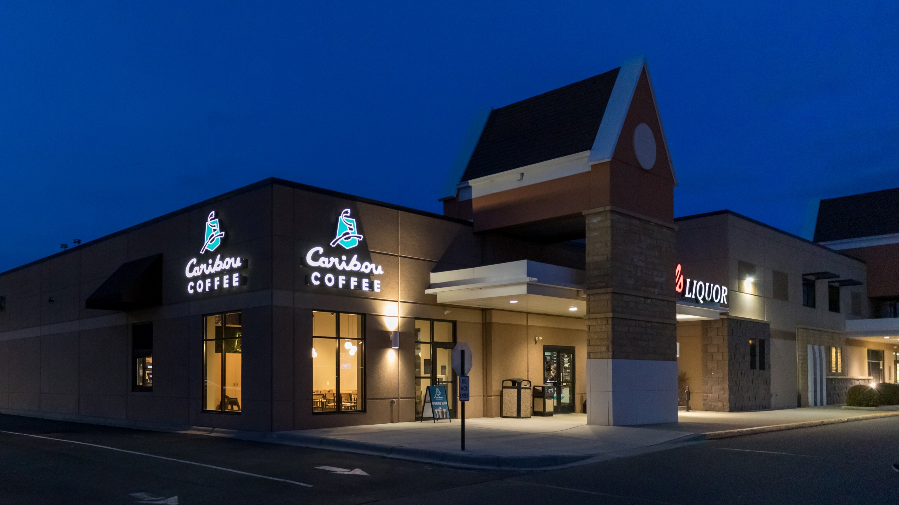 Exterior of Caribou Coffee retail addition at dusk showing storefront and entry, constructed by Rice Companies