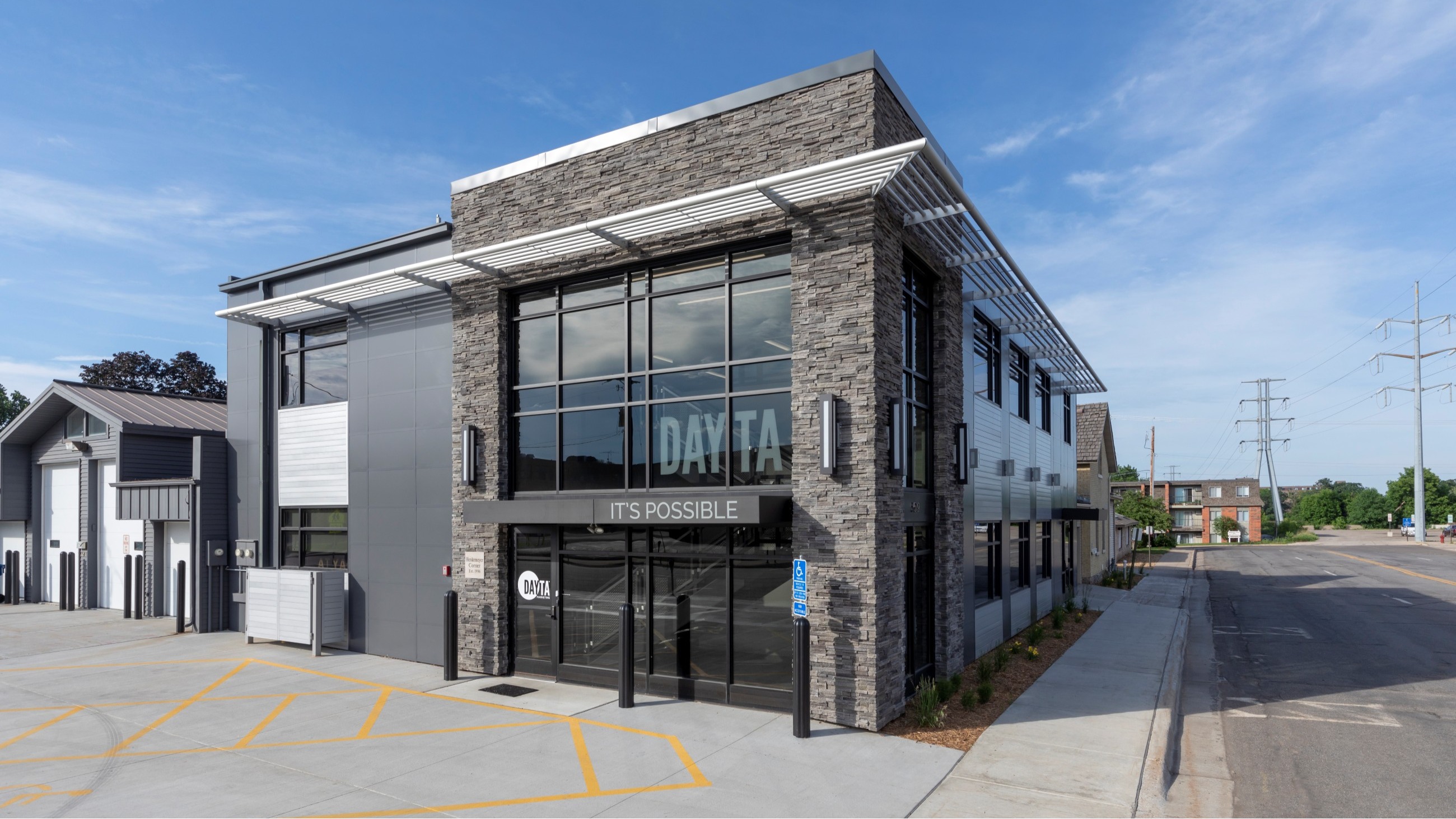 Dayta corporate office exterior with modern stone and glass entry remodeled by Rice Companies.