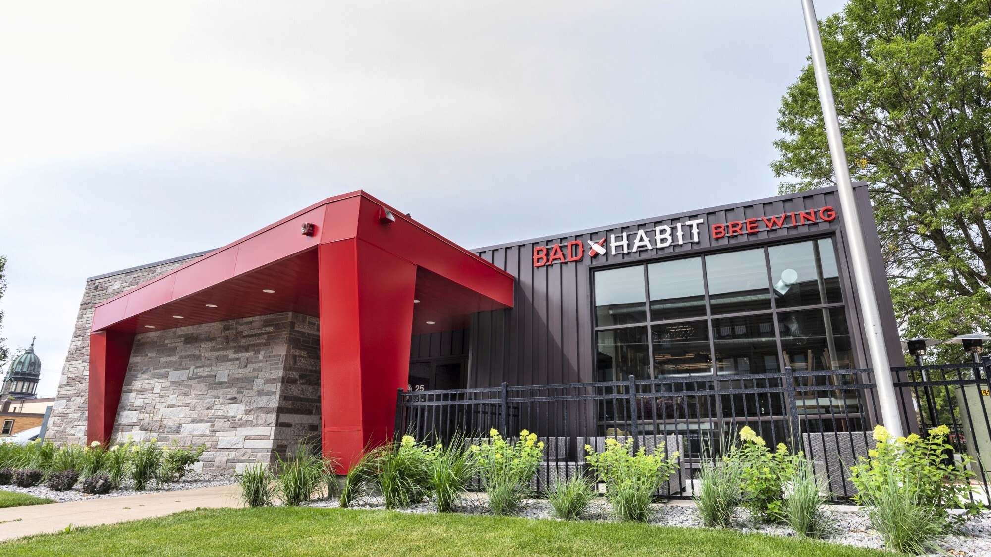 Exterior of brewery addition showing modern metal facade and entry canopy, constructed by Rice Companies