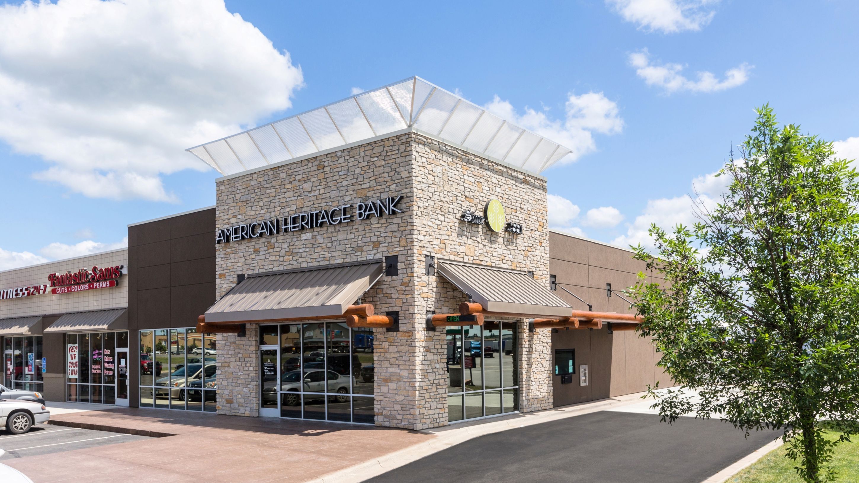 Exterior of retail bank branch showing stone facade and main entrance, constructed by Rice Companies