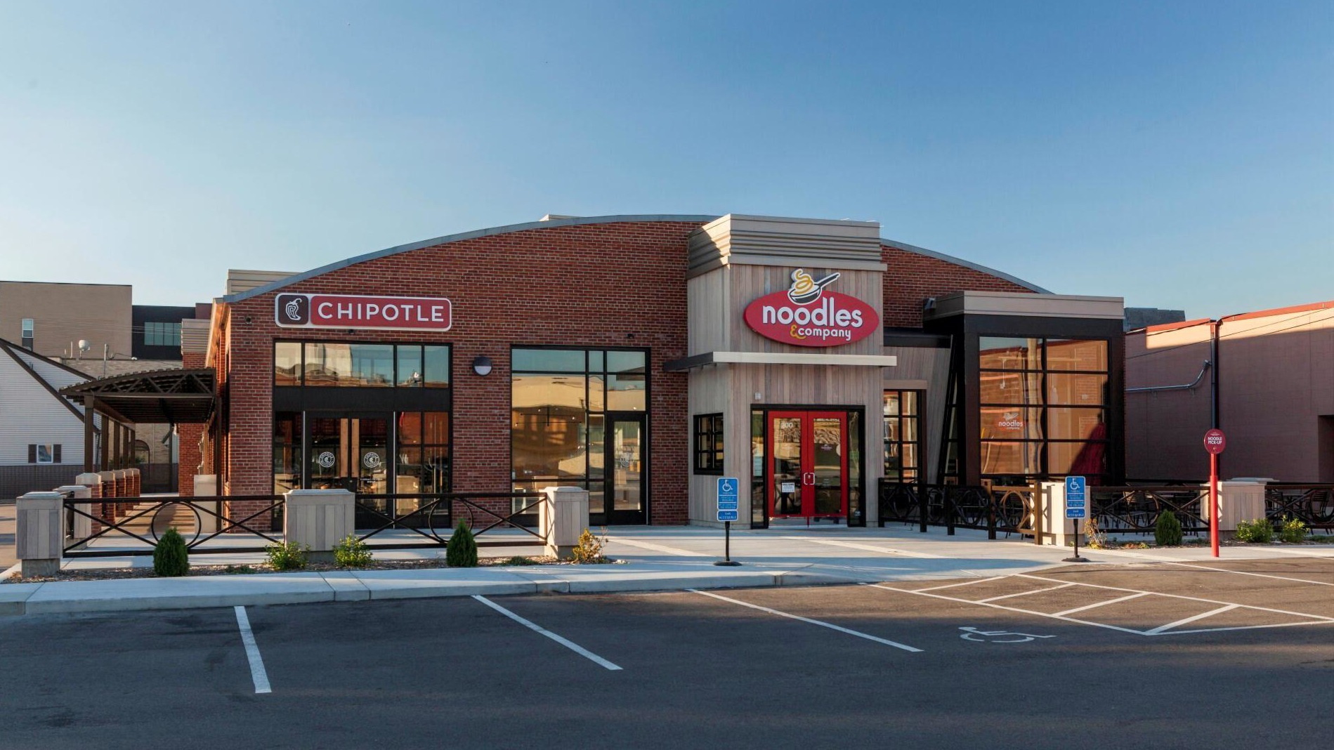 Exterior of retail building showing Chipotle and Noodles & Company storefronts, remodeled by Rice Companies