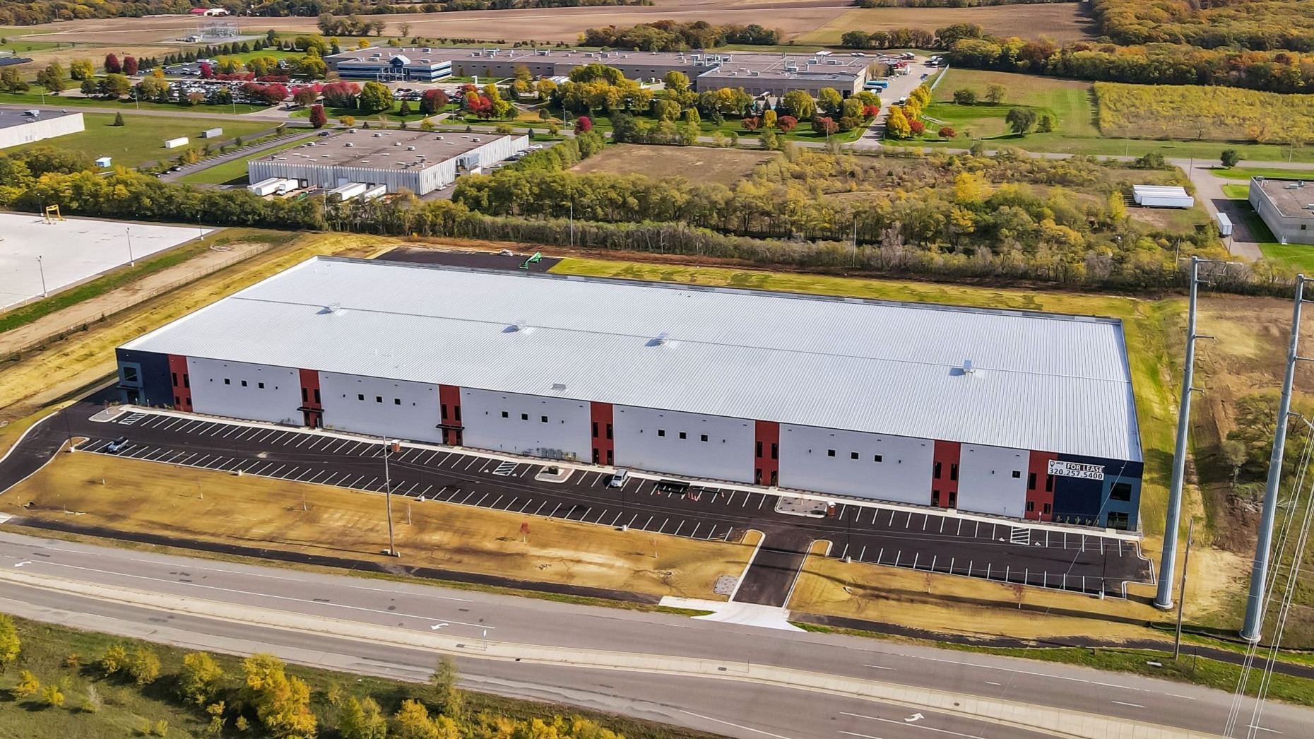 Interstate Business Center multi-tenant industrial flex building constructed by Rice Companies featuring precast exterior panels, multiple dock doors, and expansive parking area.