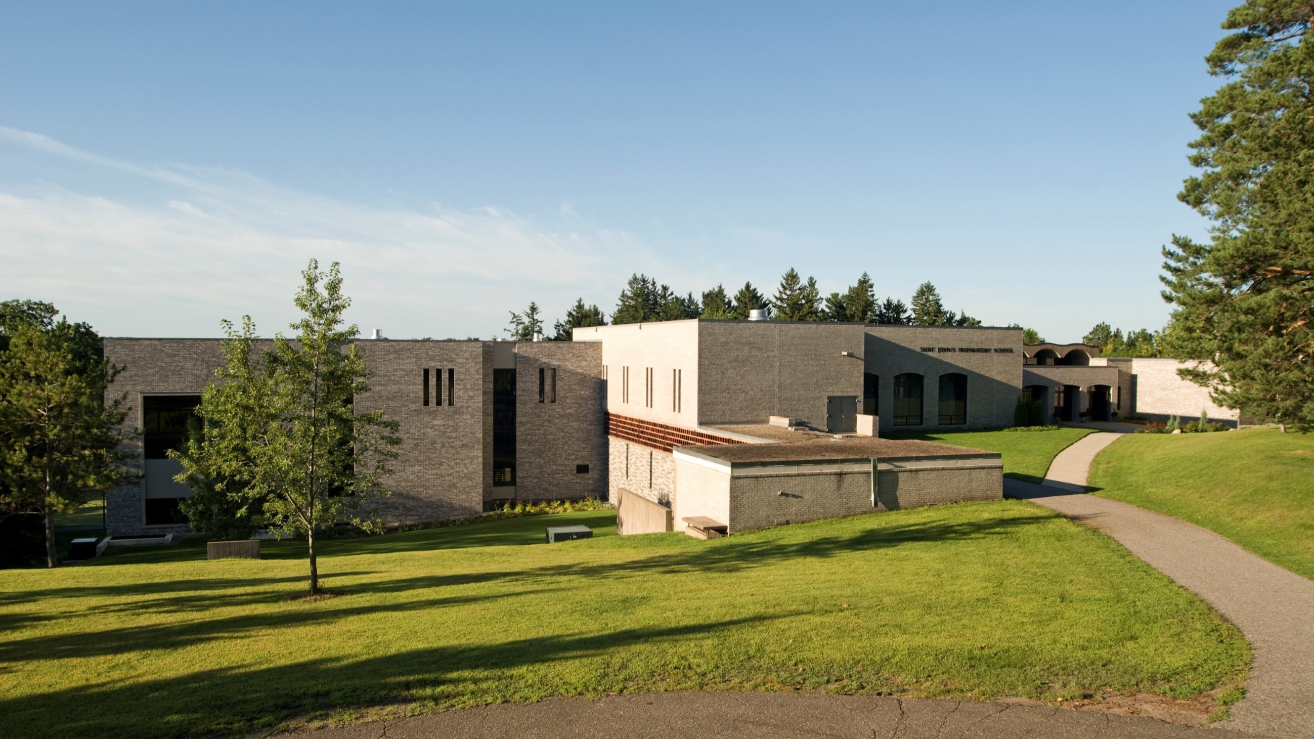 Exterior of academic building with brick exterior and campus lawn, constructed by Rice Companies