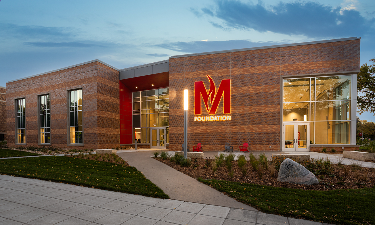 Exterior of alumni center featuring curtain wall and campus-facing entrance, constructed by Rice Companies
