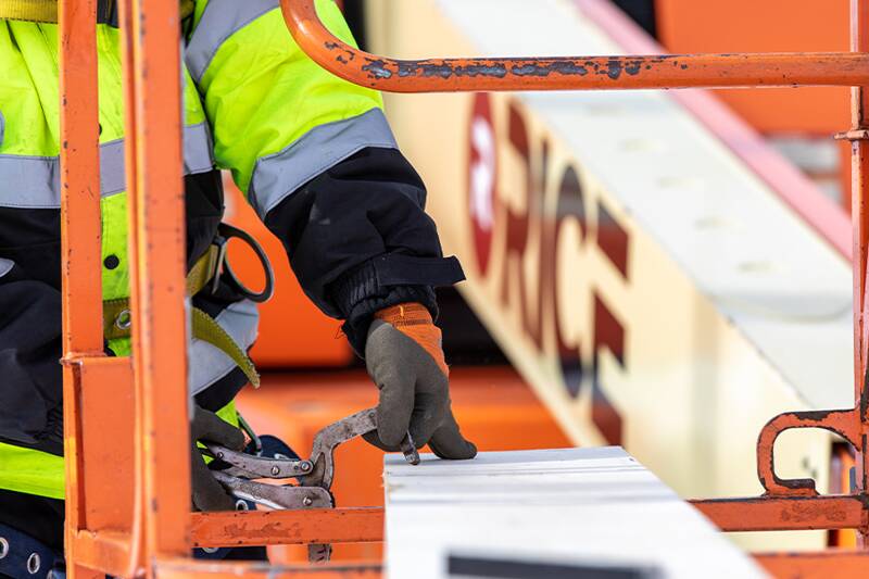 Man marking a board with a pencil