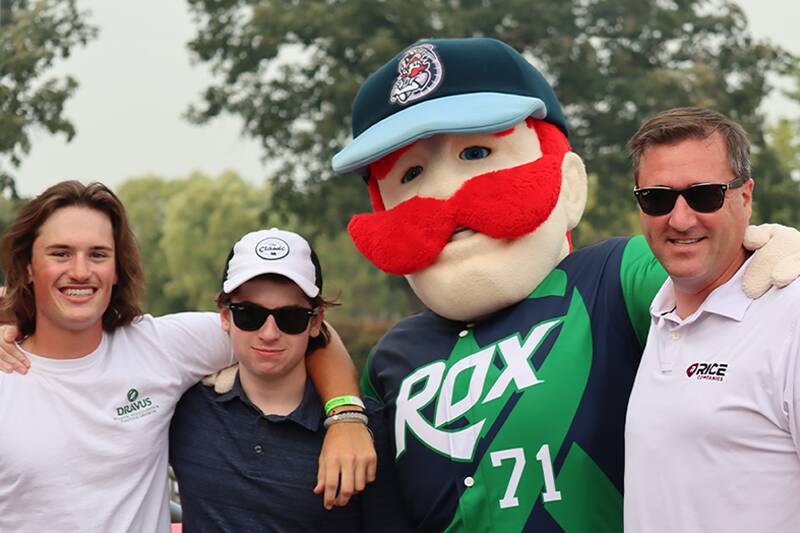 Family with mascot at a baseball game