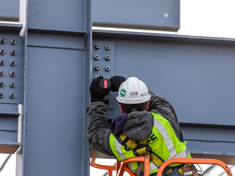 Worker working on steel building frame