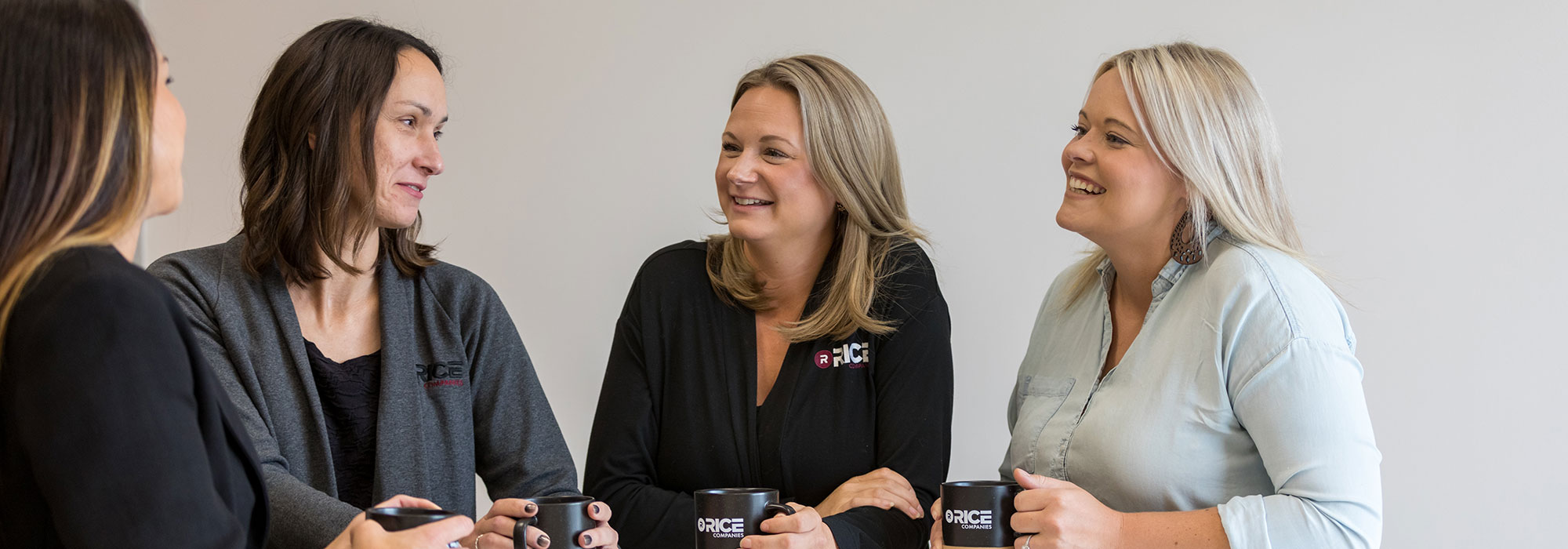 Professional women smiling, talking