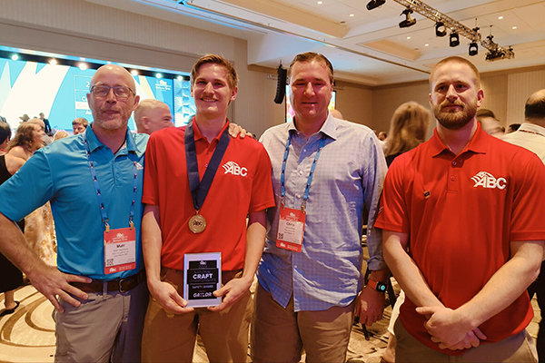 Four men posing for photo at awards banquet