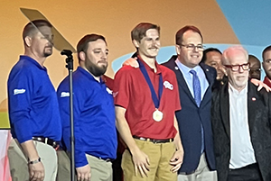 Man receiving goal medal at awards ceremony