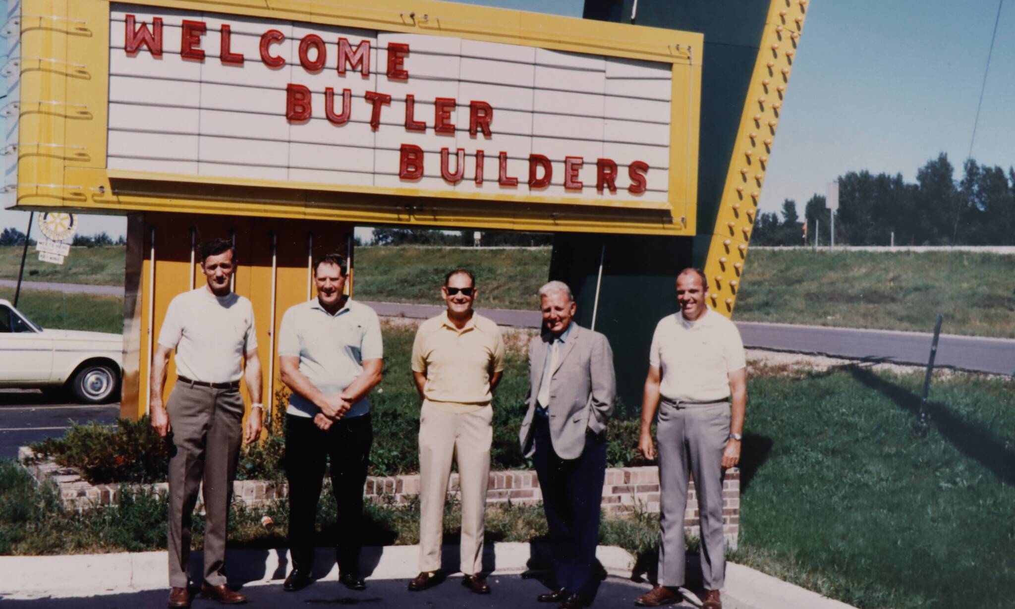 Historical photo in front of a marquee sign